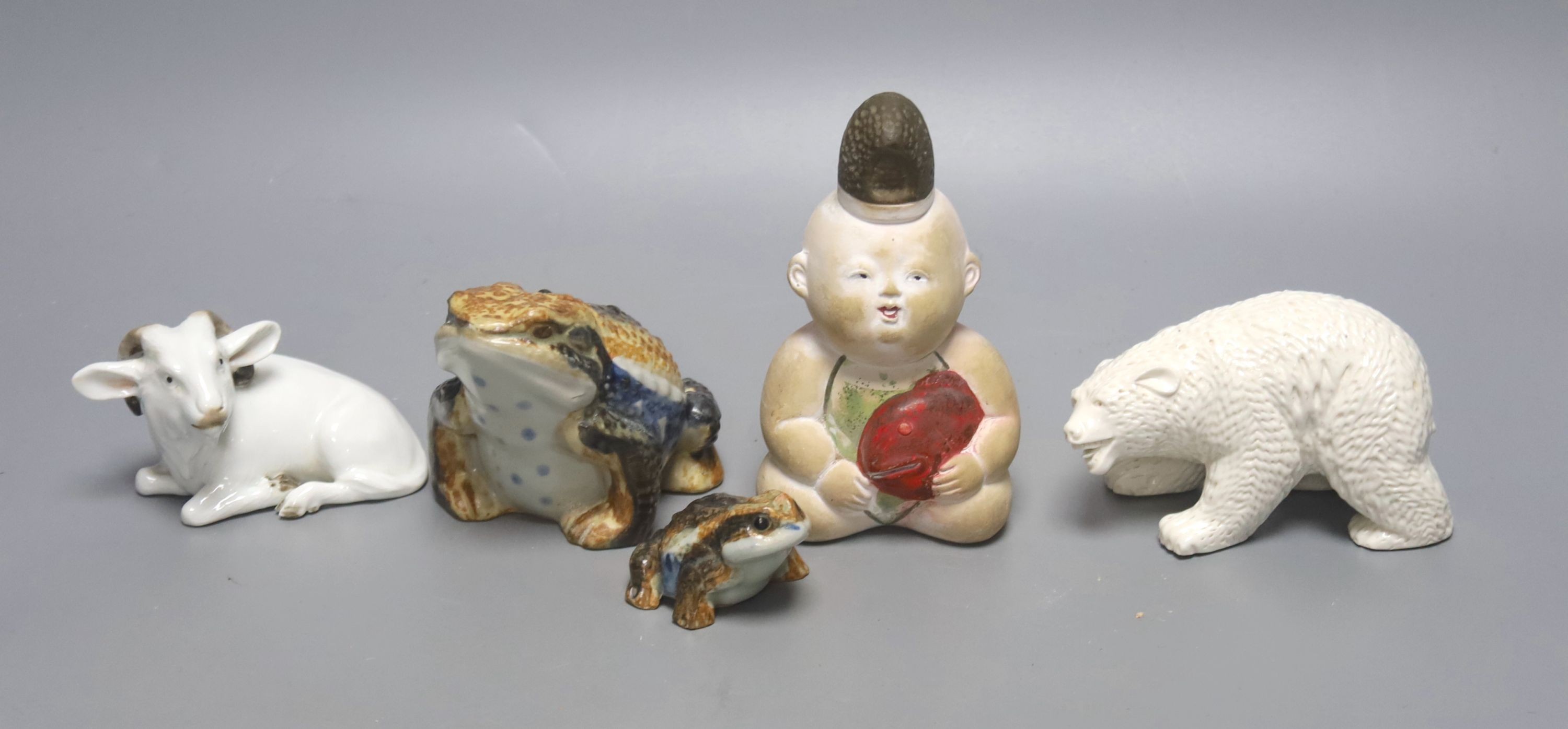 A Japanese Hirado porcelain figure of a polar bear, a Japanese porcelain figure of a ram, two figures of toads and a doll figure